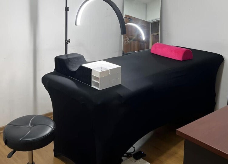 Modern treatment room at The Bae Dazzle, Johor Bahru, Johor, MY featuring a black massage bed and modern decor.