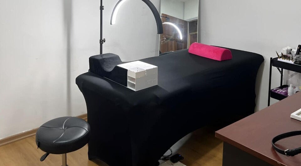 Modern treatment room at The Bae Dazzle, Johor Bahru, Johor, MY featuring a black massage bed and modern decor.