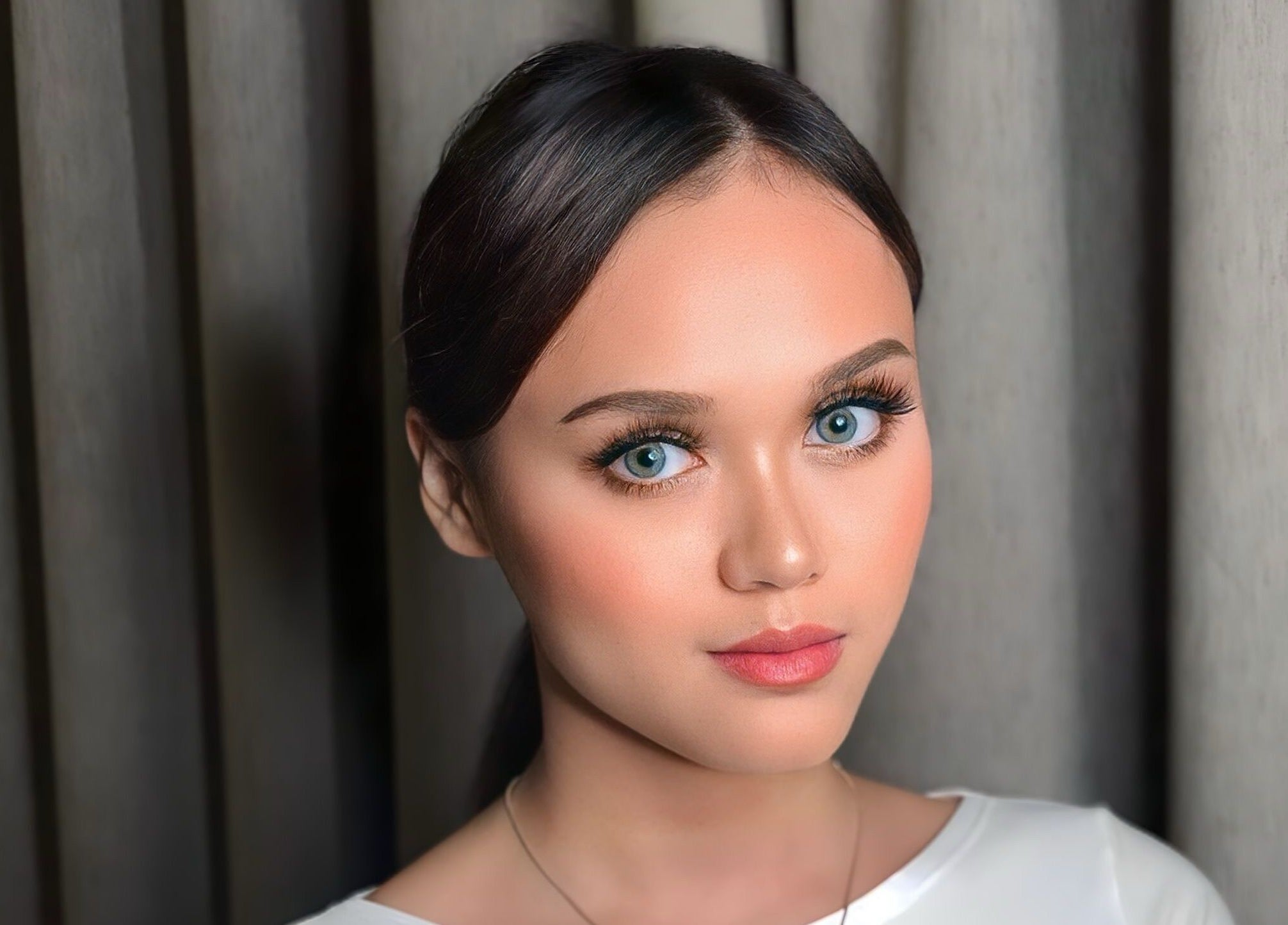 Woman with flawless makeup at The Bae Dazzle in Johor Bahru, Johor, MY, showcasing beauty services.