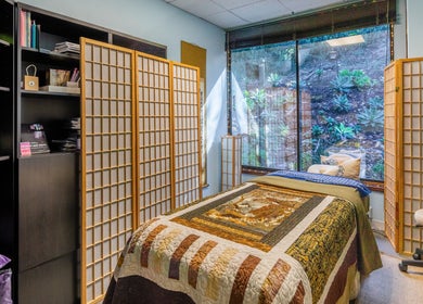 Relaxing treatment room at San Diego Reiki (Mission Valley), San Diego, CA, US with natural decor and large window view.