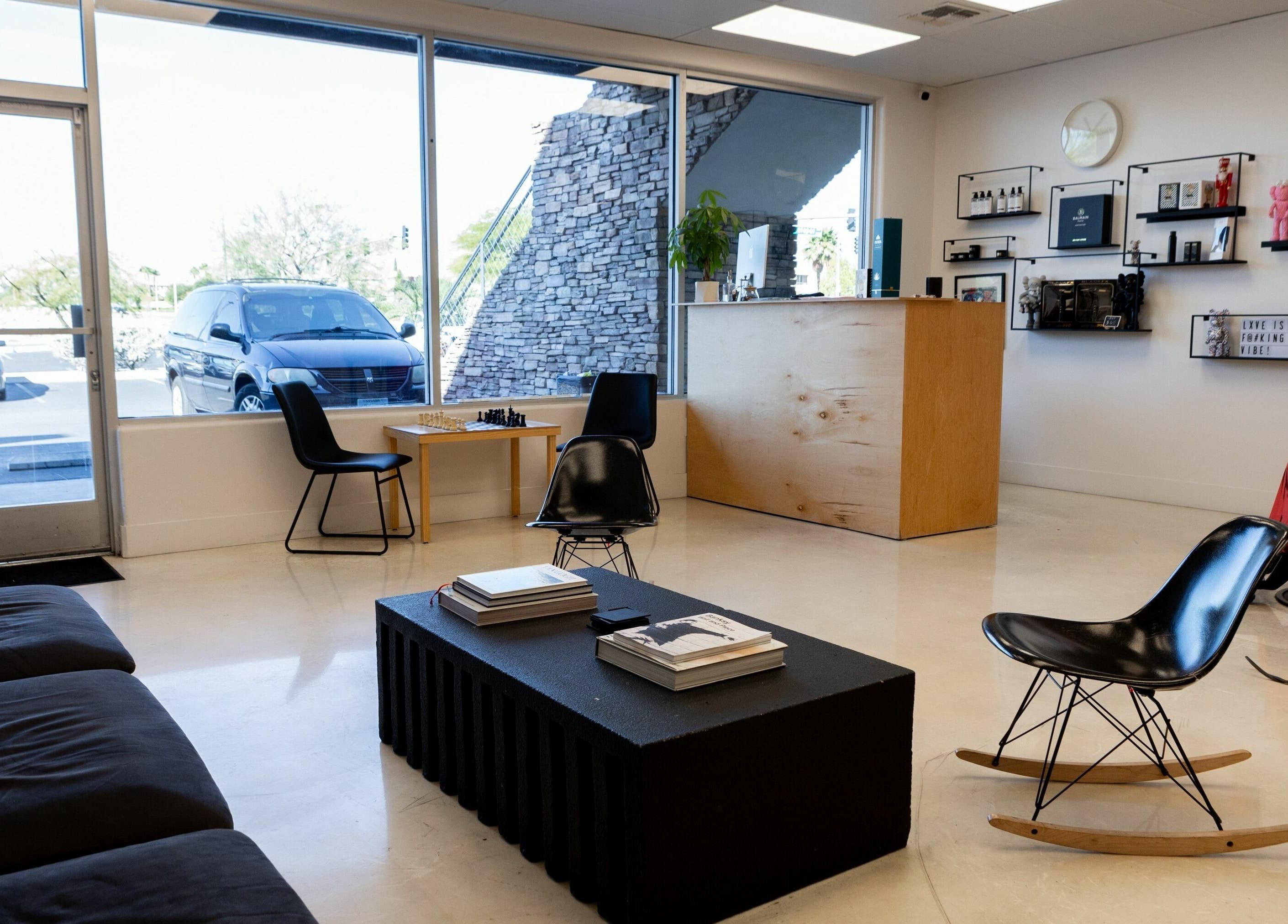 Modern seating area in Lxve Studios, Las Vegas, Nevada, US with sleek furniture and large windows.