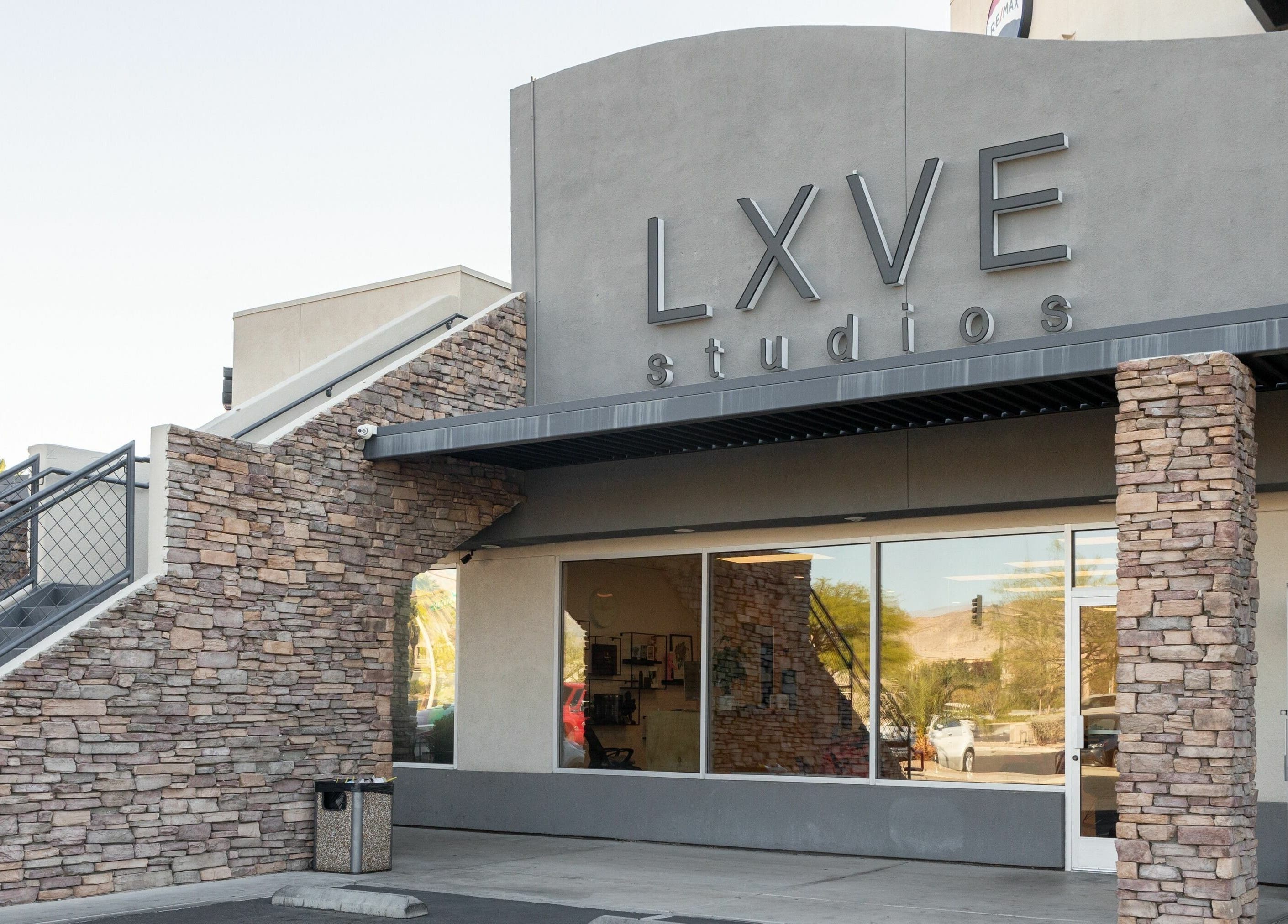 Entrance of Lxve Studios in Las Vegas, Nevada, US showcasing stone facade and large windows.