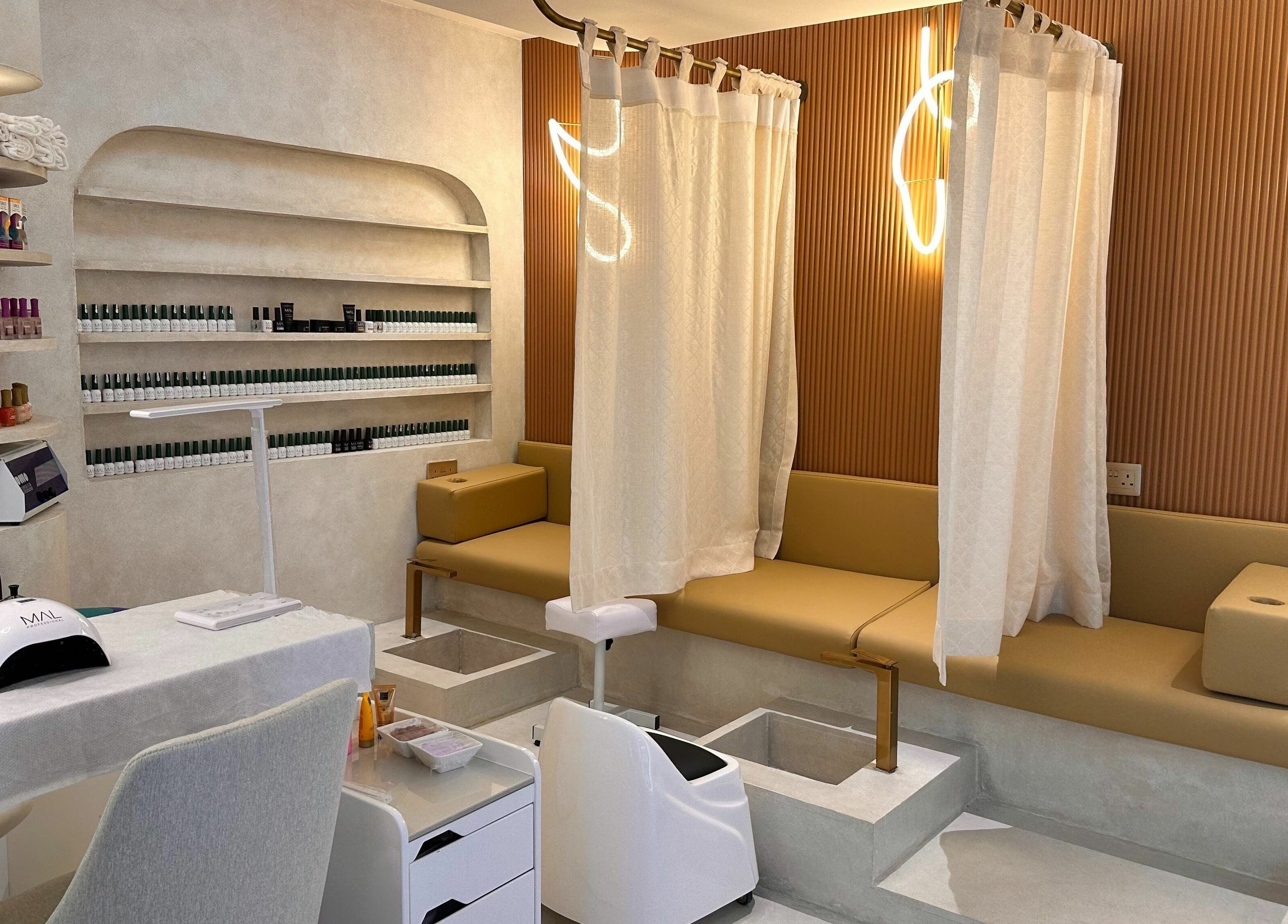 Elegant nail treatment area at Jaw Beauty Salon in Abu Dhabi, AE featuring luxurious seating and modern decor.
