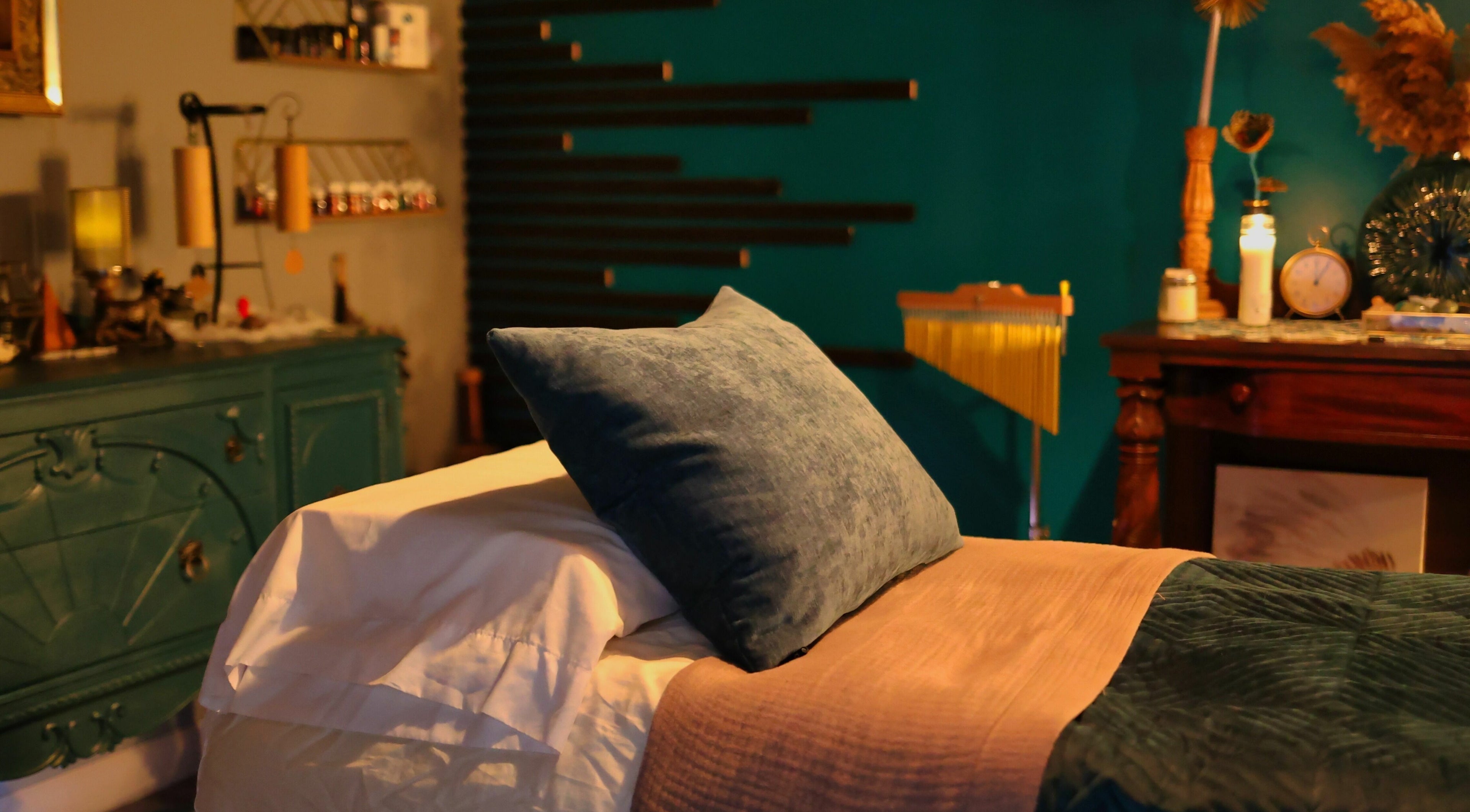 Cozy massage room at Aura Holistic and Metaphysical Wellness in Aurora, Illinois, US, with peaceful decor.