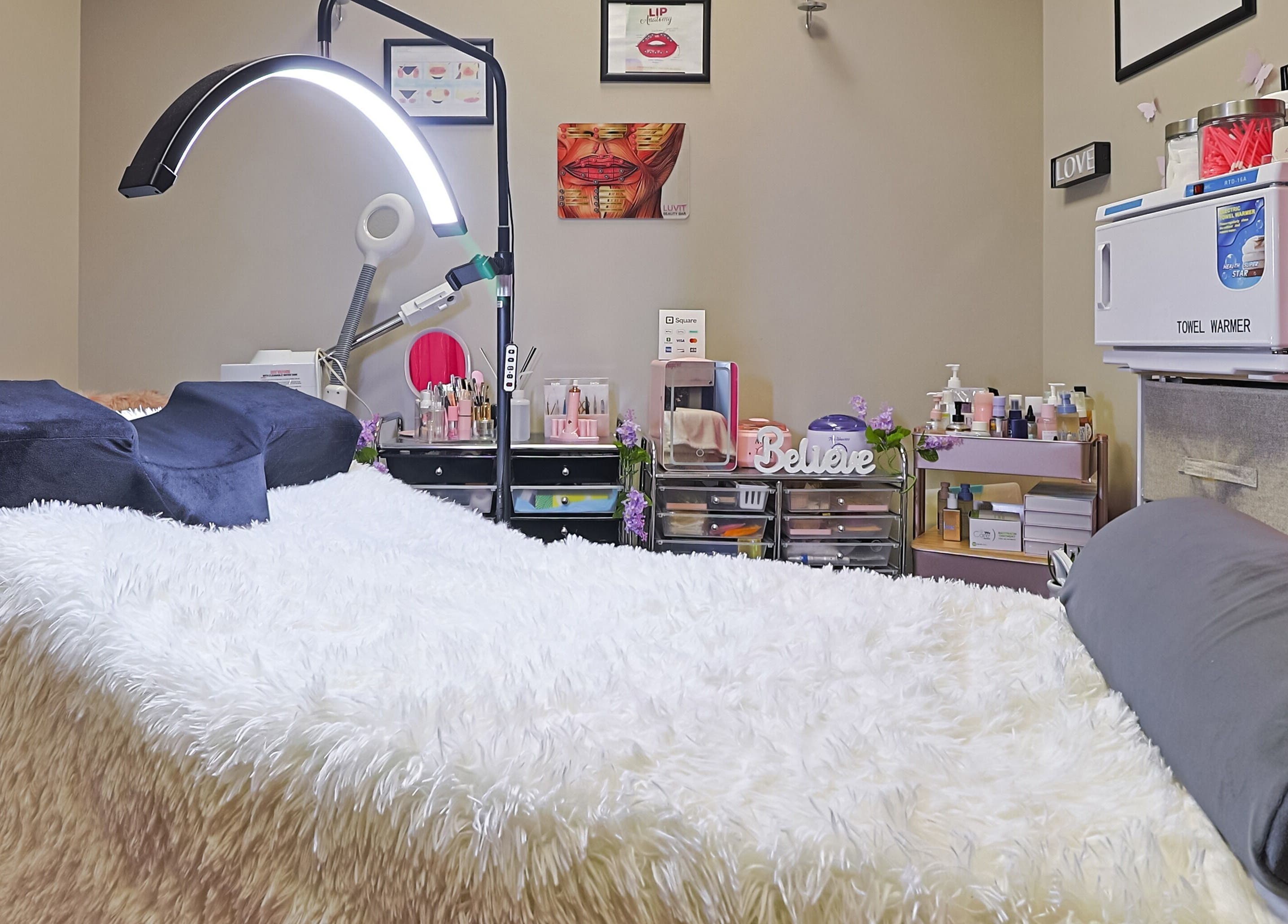 Luvit Beauty Bar treatment room with a cozy bed and beauty tools in Hoboken, New Jersey, US.