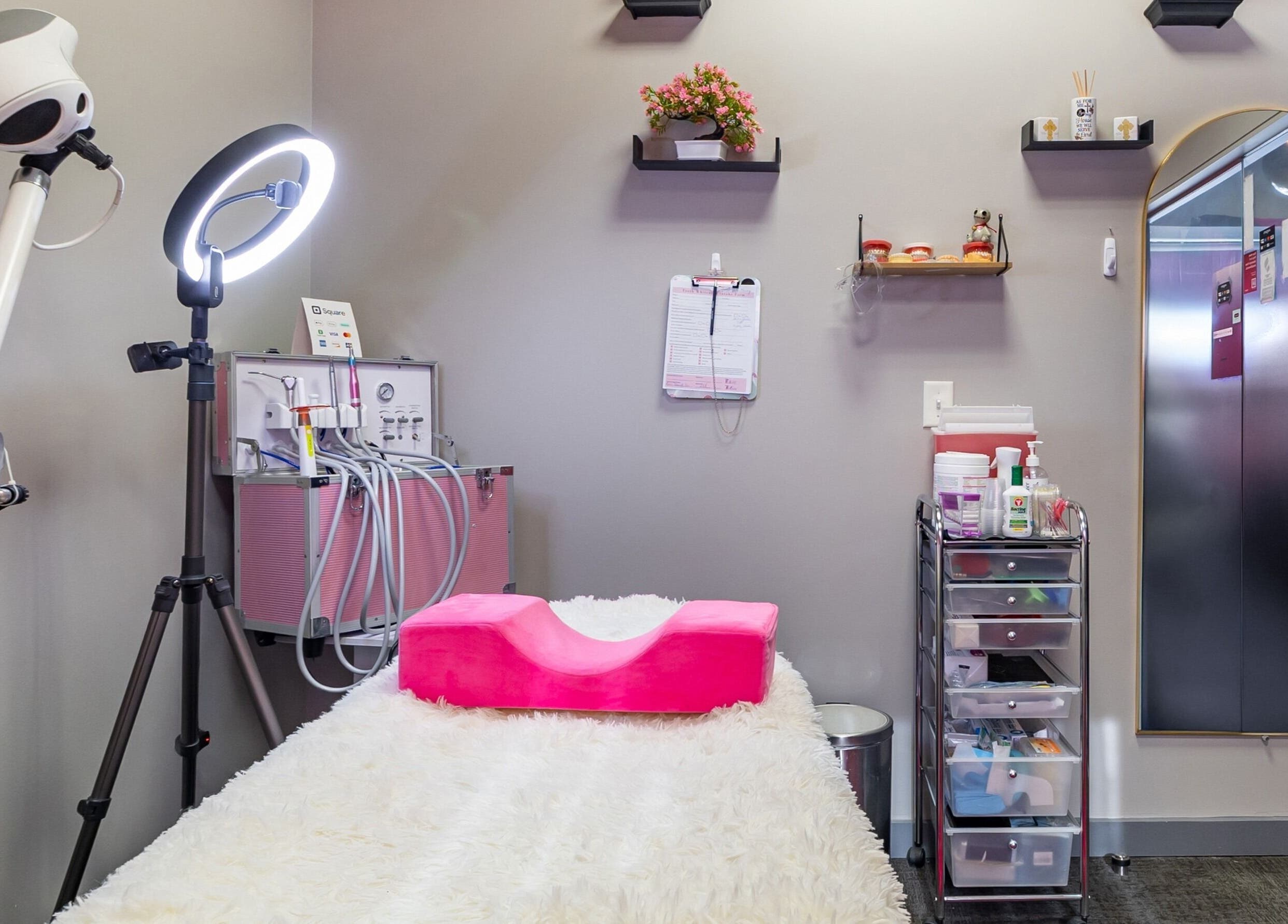Cozy treatment room at Luvit Beauty Bar in Hoboken, New Jersey, US, featuring spa equipment and a fluffy bed.