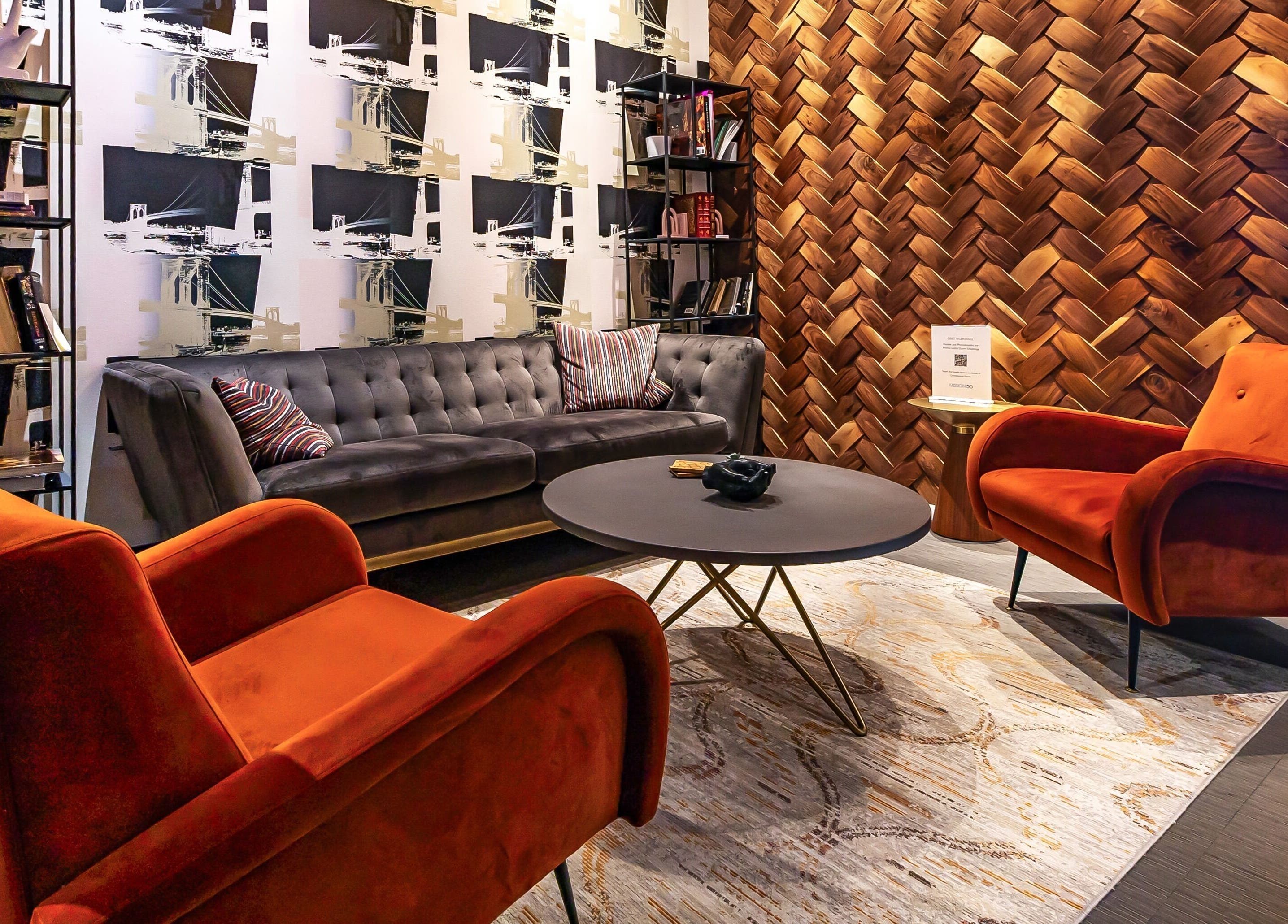 Cozy seating area at Luvit Beauty Bar, Hoboken, New Jersey, US featuring plush chairs and a stylish backdrop.