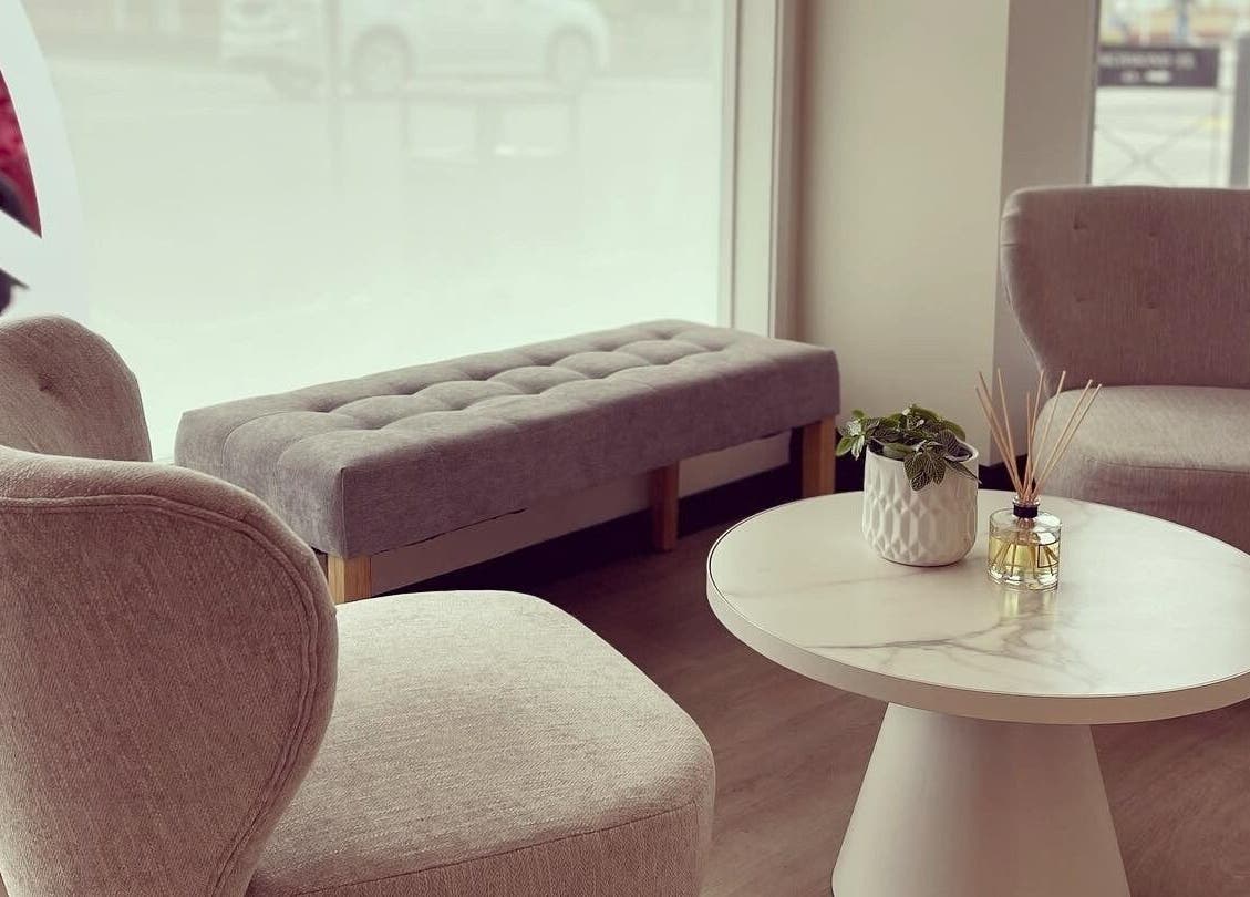 Calm seating area at Diamond Day Spa, Lower Hutt, Wellington, NZ with grey chairs and white table.