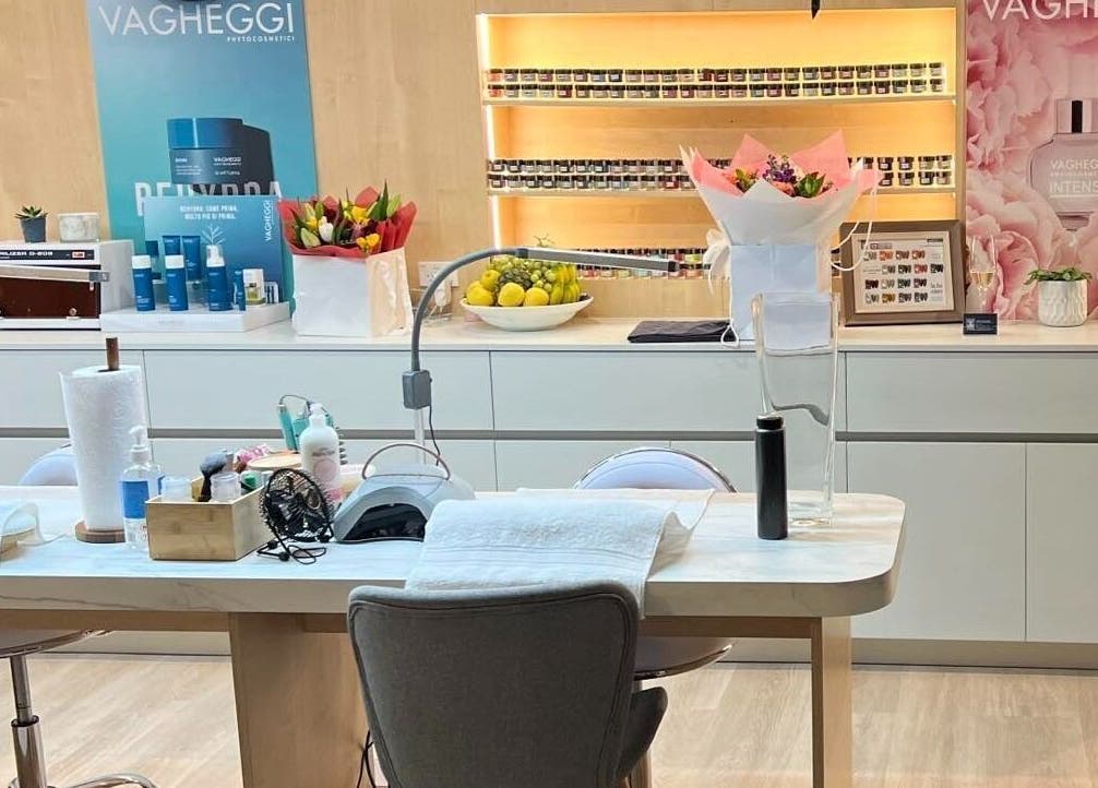 Manicure station at Diamond Day Spa, Lower Hutt, Wellington, NZ, displaying vibrant products and flowers.