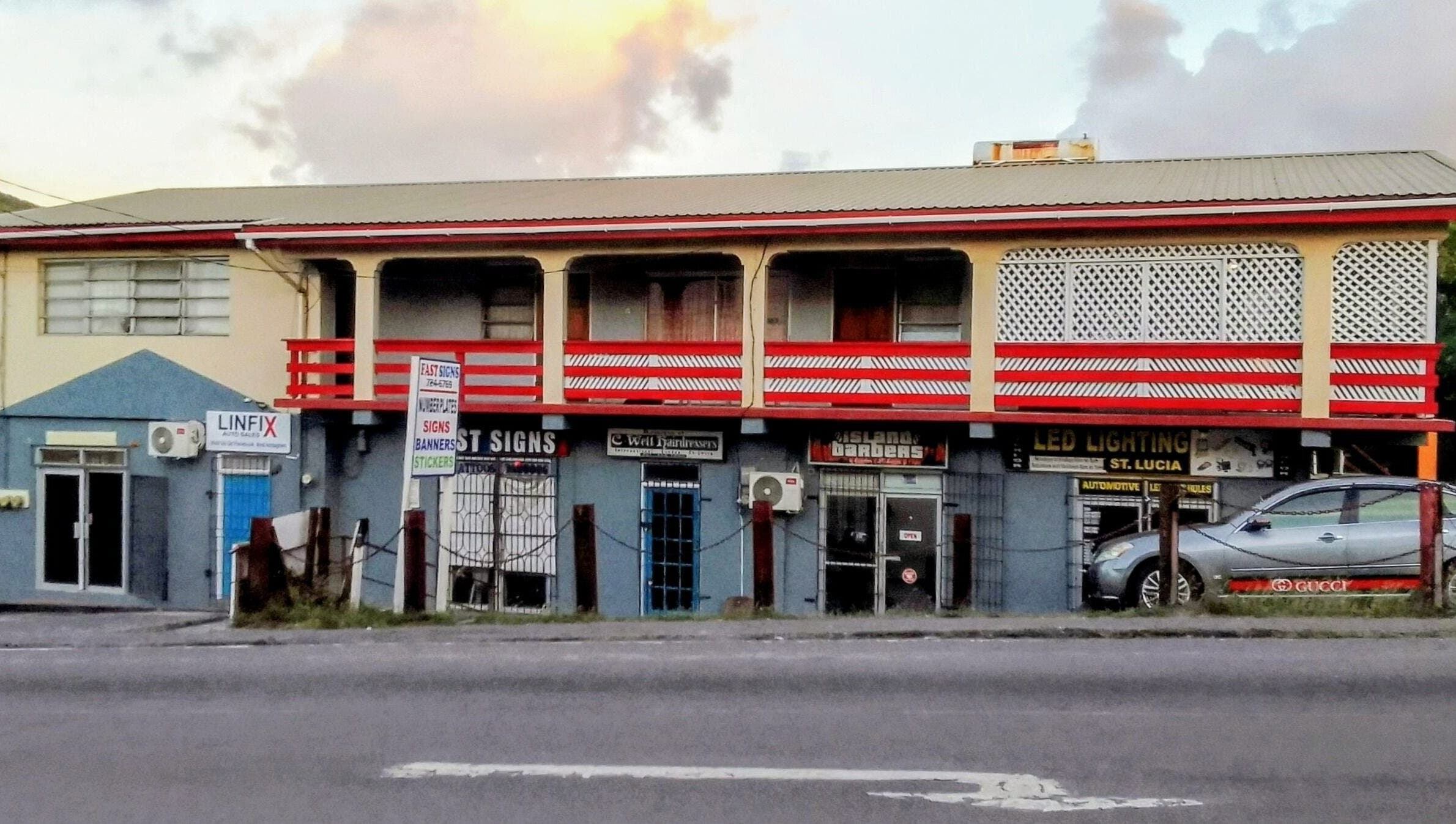 Bright facade of The StLucian Goddess Nail Salon, Gros Islet, LC, with colorful signage.