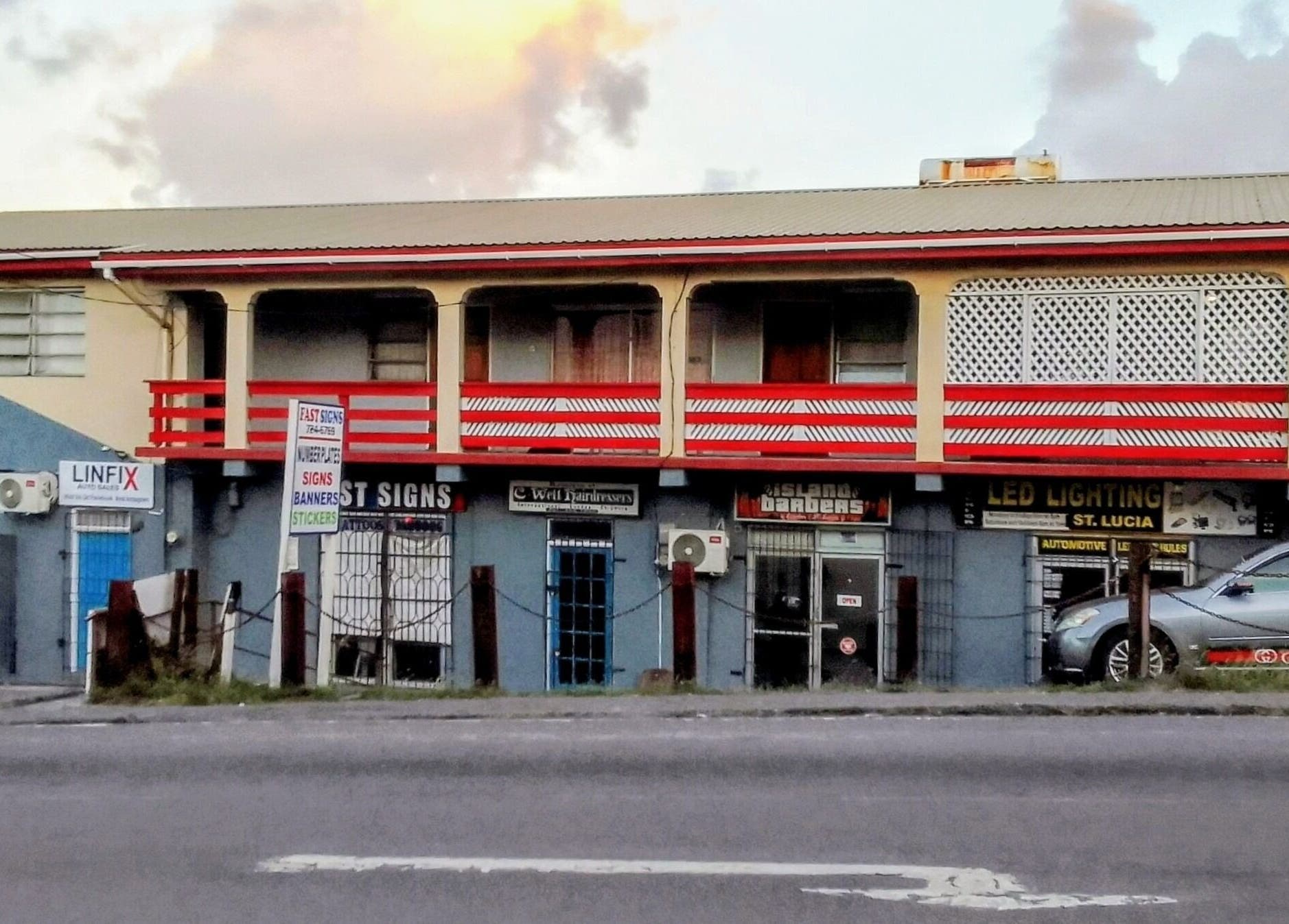 Bright facade of The StLucian Goddess Nail Salon, Gros Islet, LC, with colorful signage.