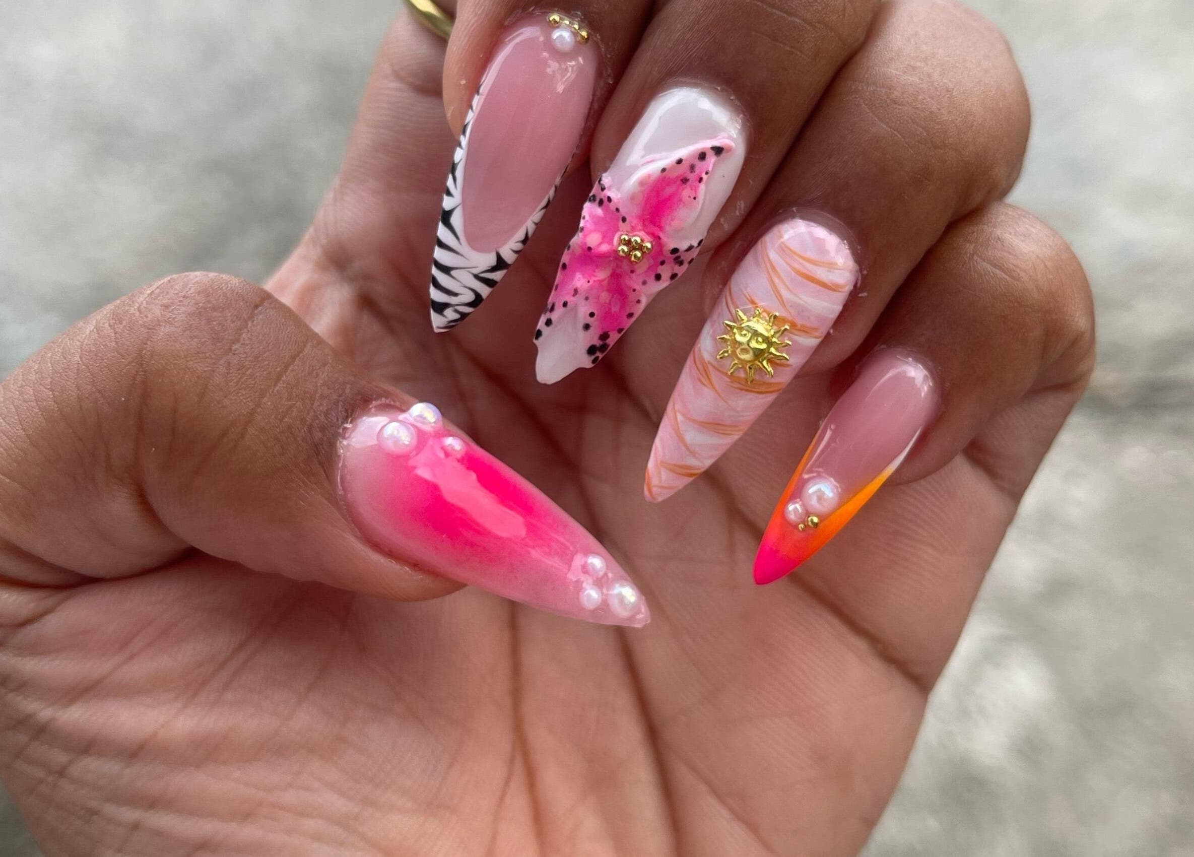 Unique nail art at The StLucian Goddess Nail Salon, Gros Islet, LC showcasing bright colors and intricate designs.