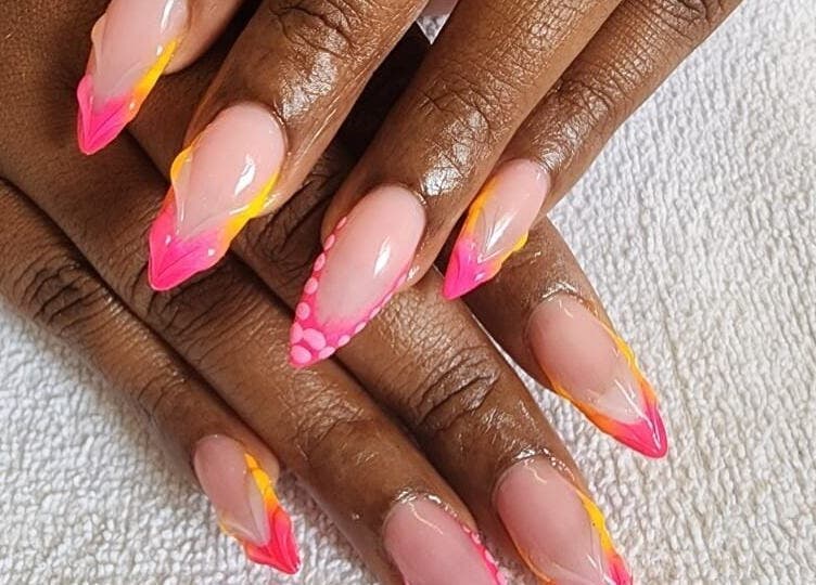 Bright pink and yellow nail art at The StLucian Goddess Nail Salon in Gros Islet, LC.