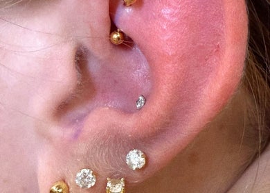 Multiple gold and diamond ear piercings at Rad Beauty Lab, South Jordan, Utah, US.