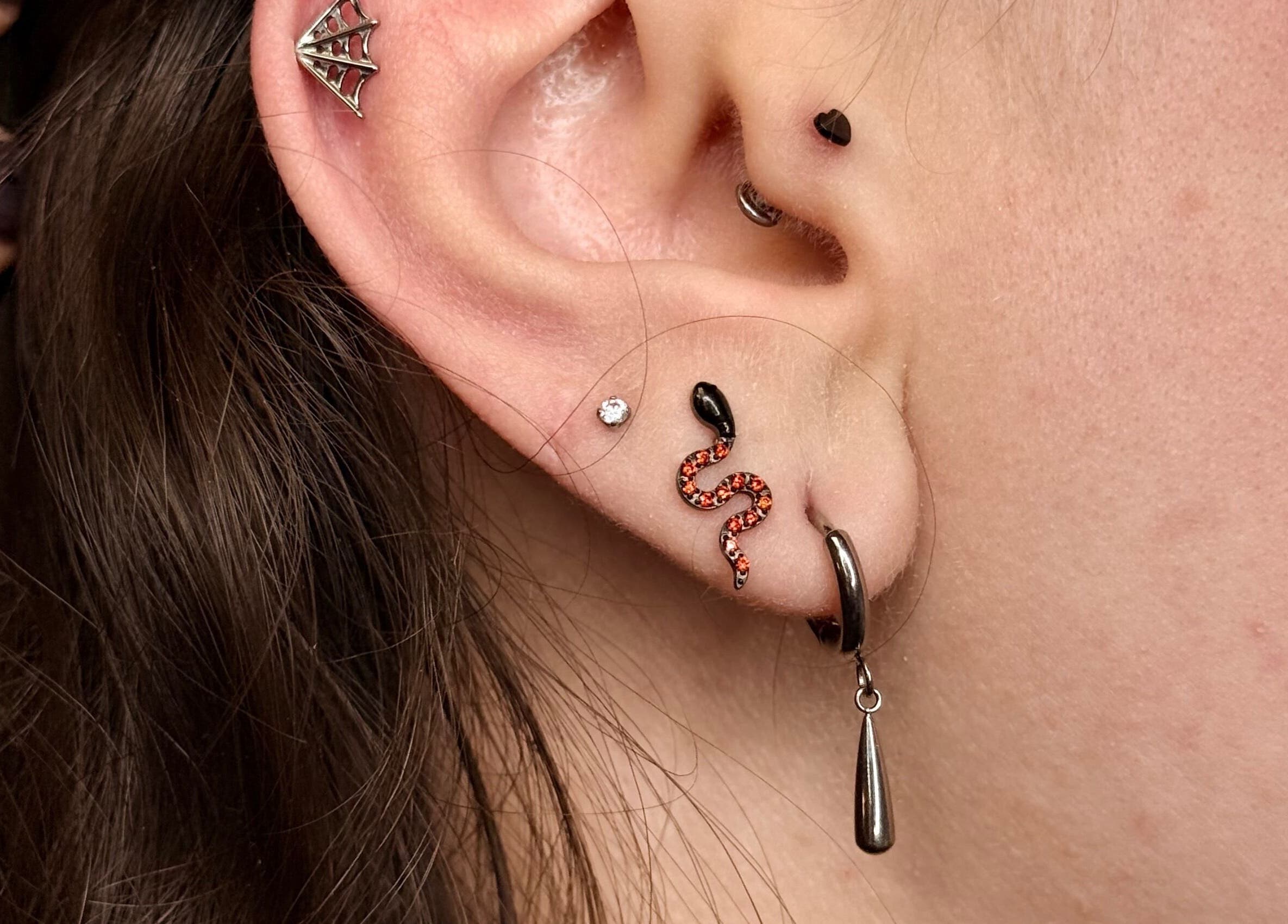 Trendy ear piercings at Rad Beauty Lab, South Jordan, Utah, US, showcasing unique jewelry designs.