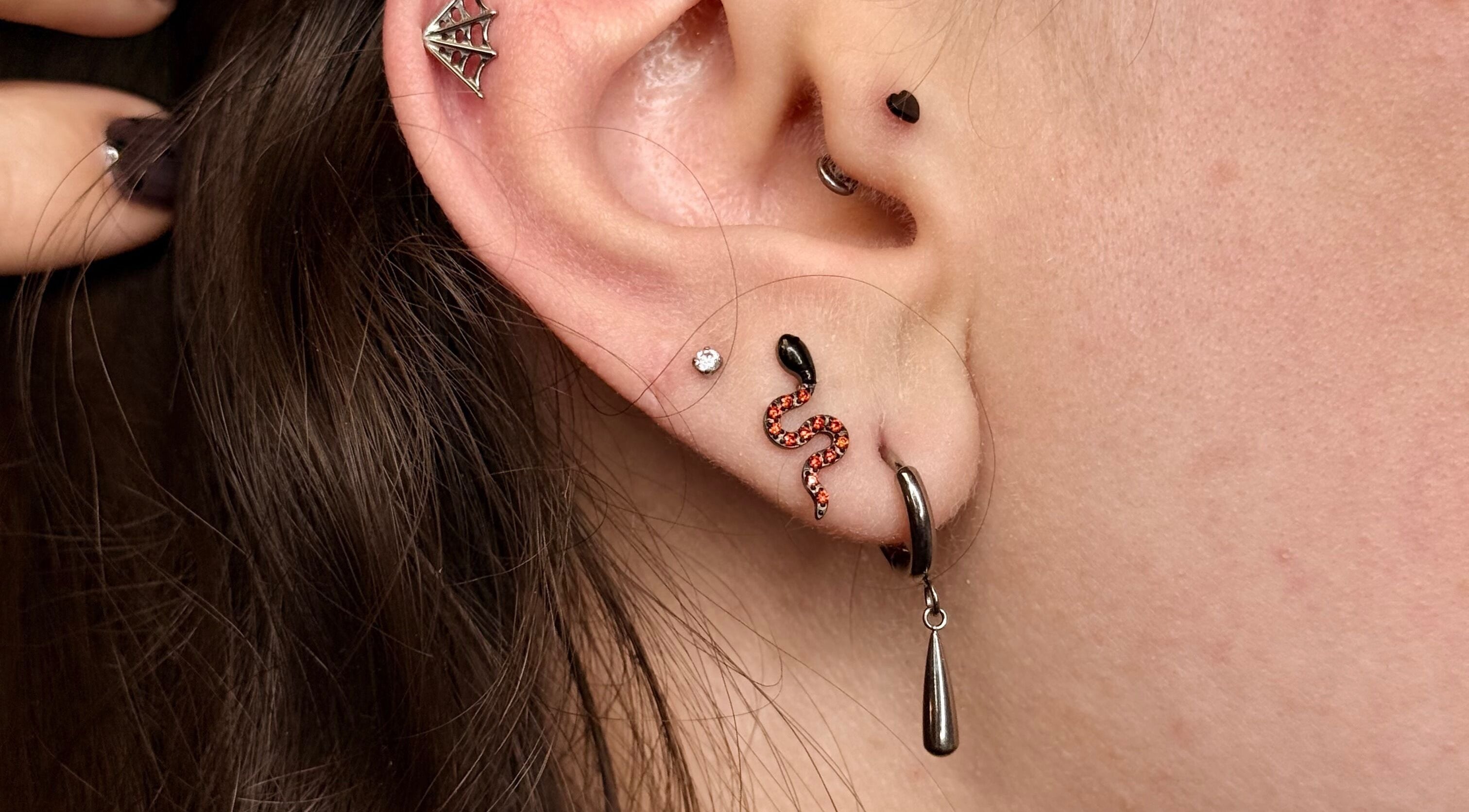 Trendy ear piercings at Rad Beauty Lab, South Jordan, Utah, US, showcasing unique jewelry designs.