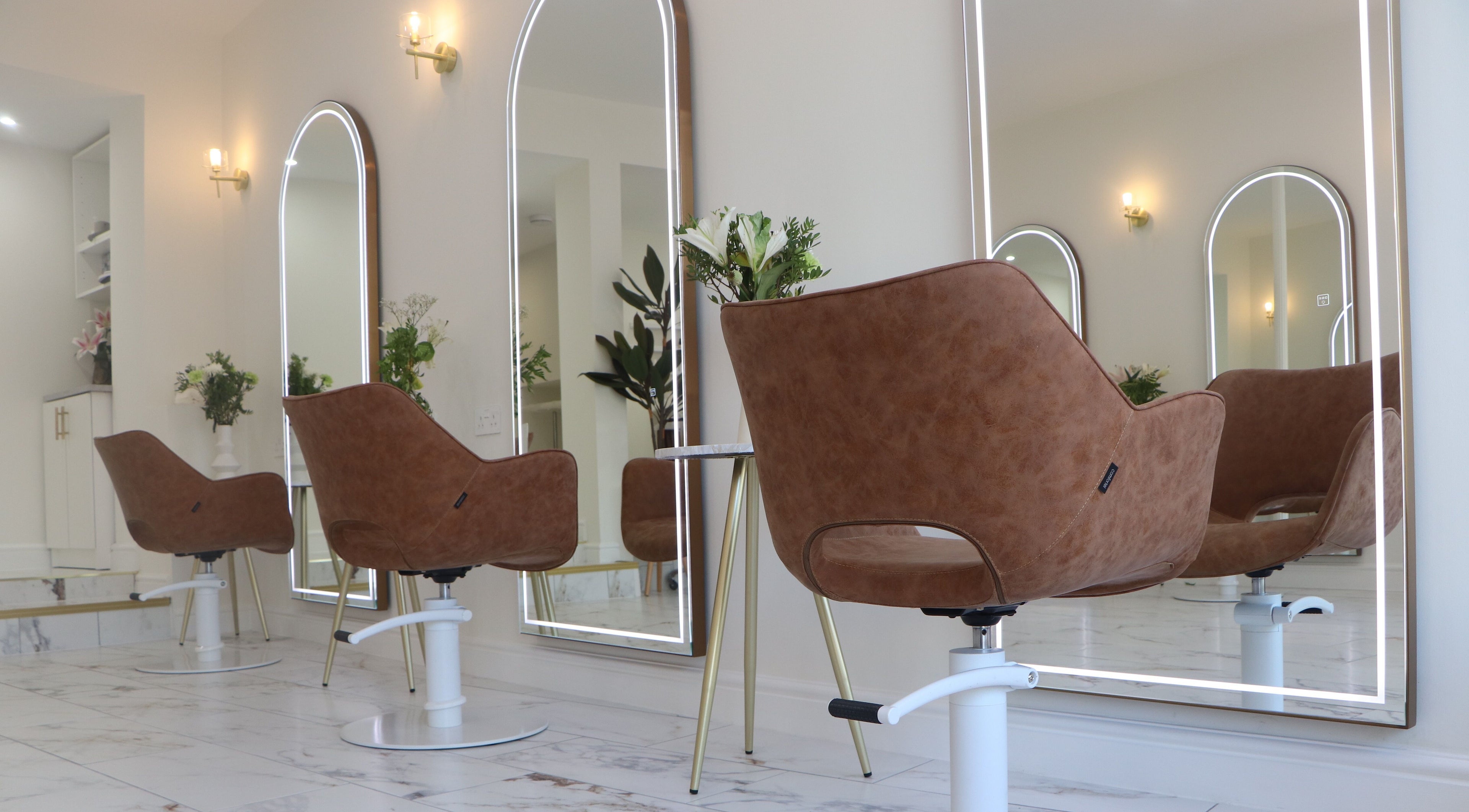 Luxurious salon interior with stylish chairs and mirrors at PS Hair Co., Royal Tunbridge Wells, England, GB.