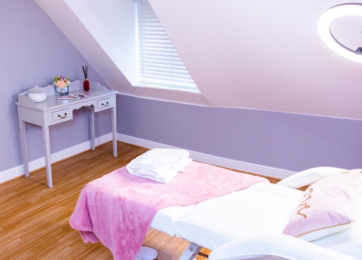 Calm treatment room at De Luxe Skin and Beauty Clinic in Maidstone, England, GB, with a plush pink blanket.