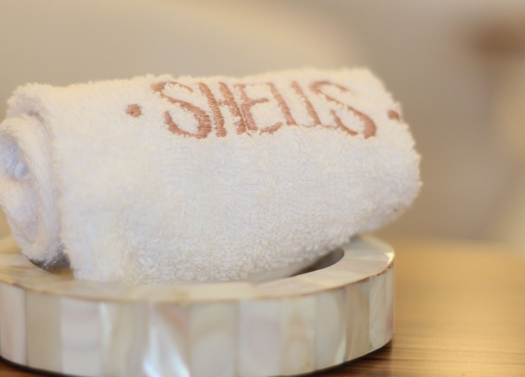 Elegant towel with Shells spa | أصداف سبا logo at Riyadh's luxury venue, منطقة الرياض, SA.