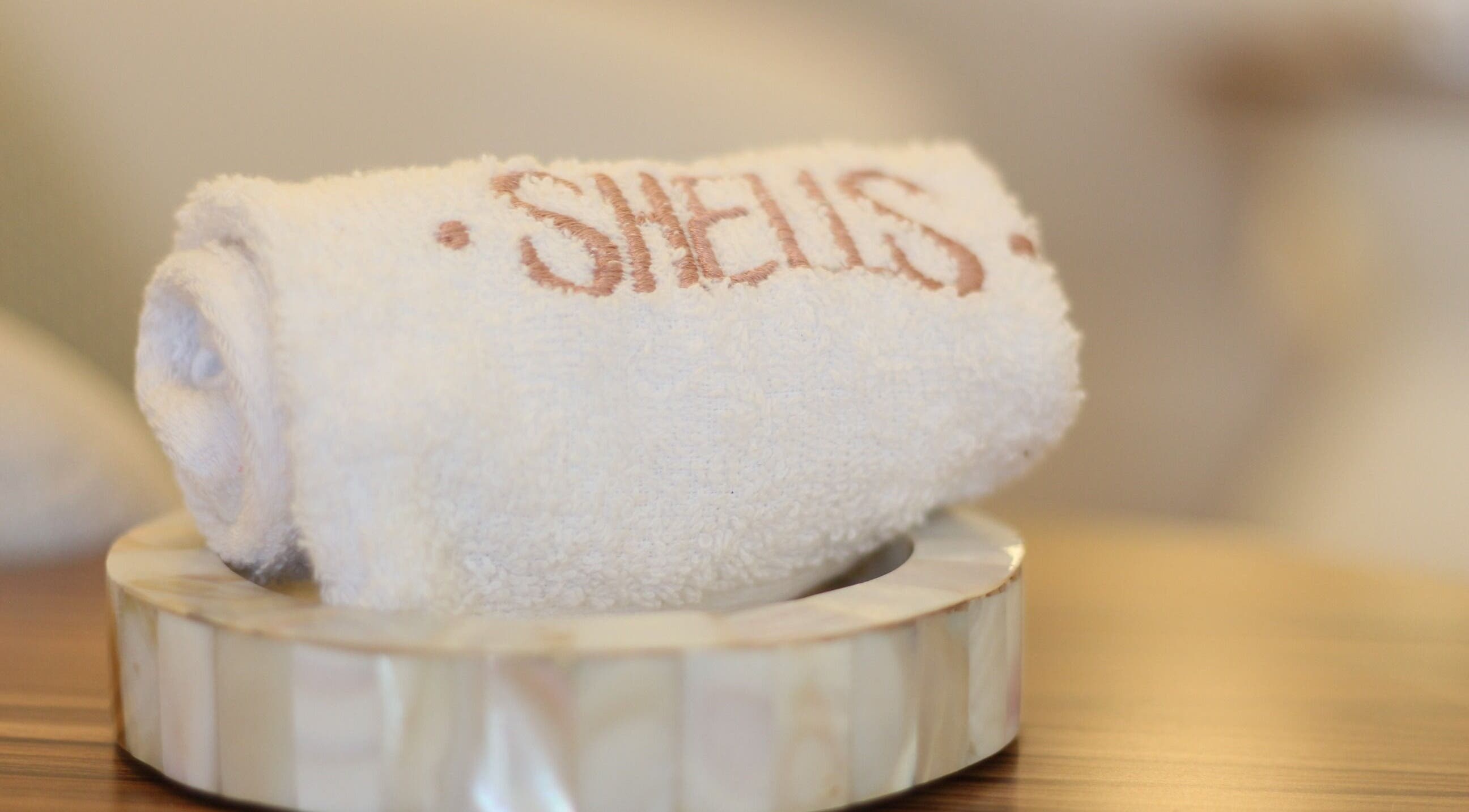 Elegant towel with Shells spa | أصداف سبا logo at Riyadh's luxury venue, منطقة الرياض, SA.