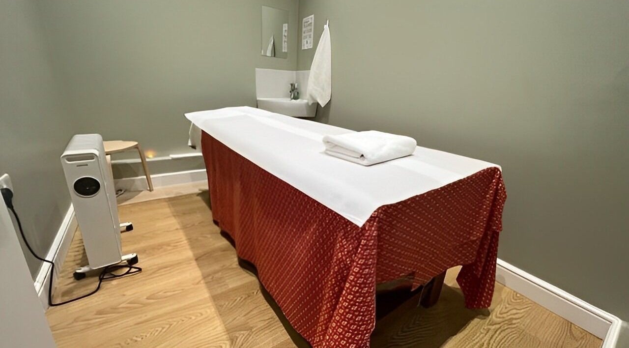 Massage room at 1010 Thai Therapy, London, England, GB, with a massage table and serene ambiance.