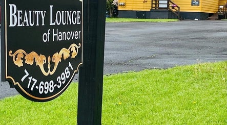 Signage for Beauty Lounge of Hanover set in green landscape, Hanover, Pennsylvania, US.