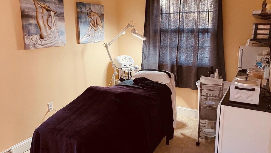 Cozy treatment room at Beauty Lounge of Hanover in Hanover, Pennsylvania, US, featuring artwork and spa bed.
