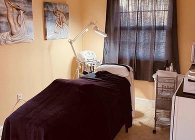 Cozy treatment room at Beauty Lounge of Hanover in Hanover, Pennsylvania, US, featuring artwork and spa bed.