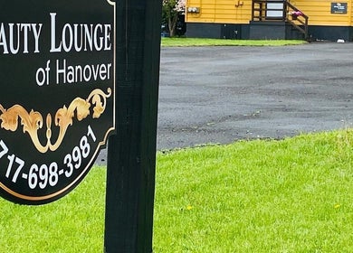 Charming sign of Beauty Lounge of Hanover, located in Hanover, Pennsylvania, US, amidst a lush green lawn.