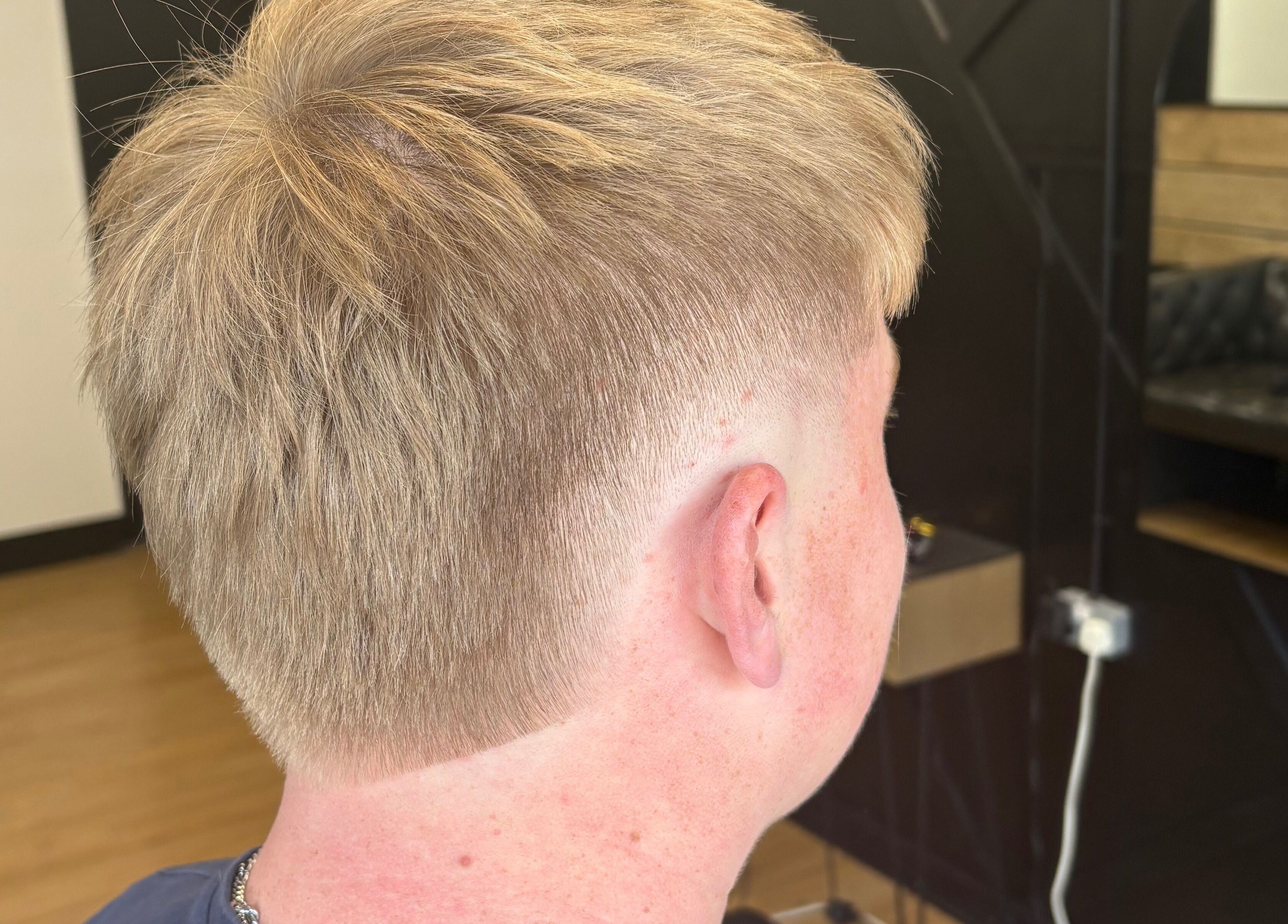 Close-up of a stylish men's haircut with a fade at Harrison’s in Rotherham, England, GB.