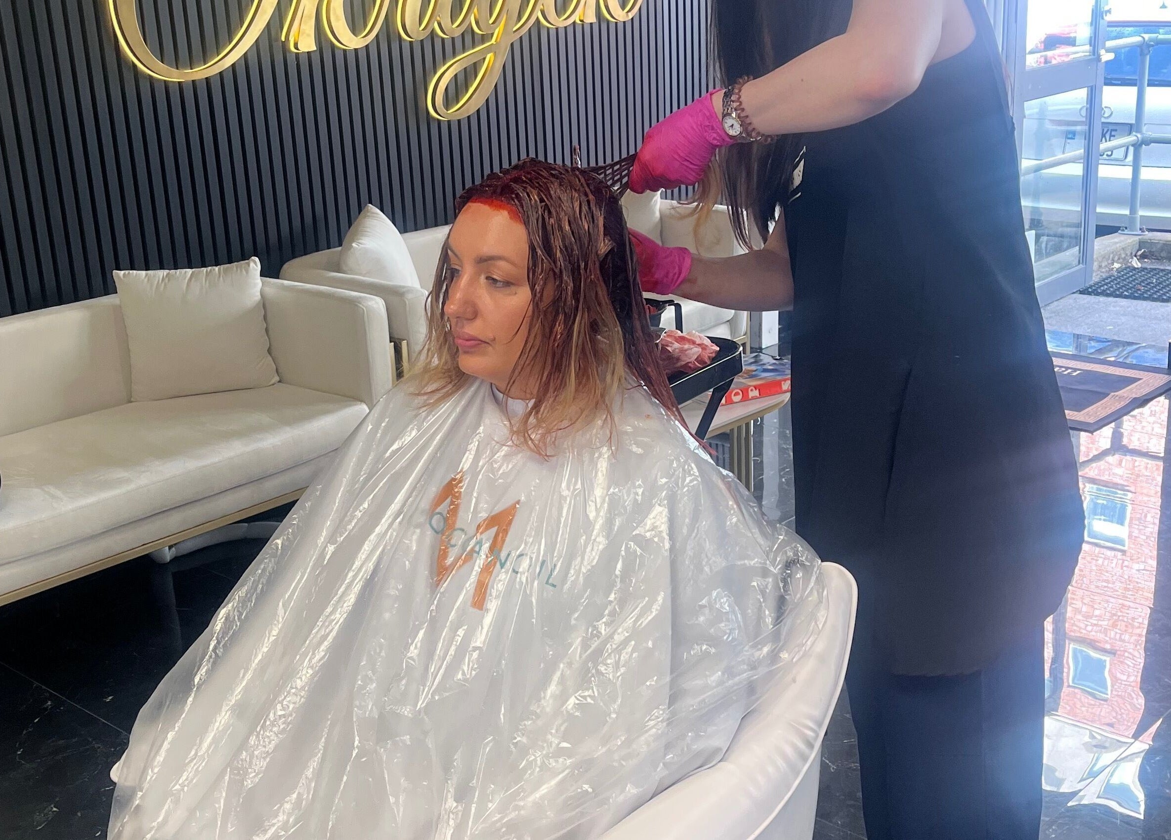 Stylist applying hair color at Hair by Okrajek, Cork, County Cork, IE.