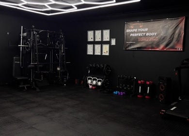 Modern gym setup at Dani T Fitness in Boksburg, Gauteng, ZA featuring weights and equipment for workouts.