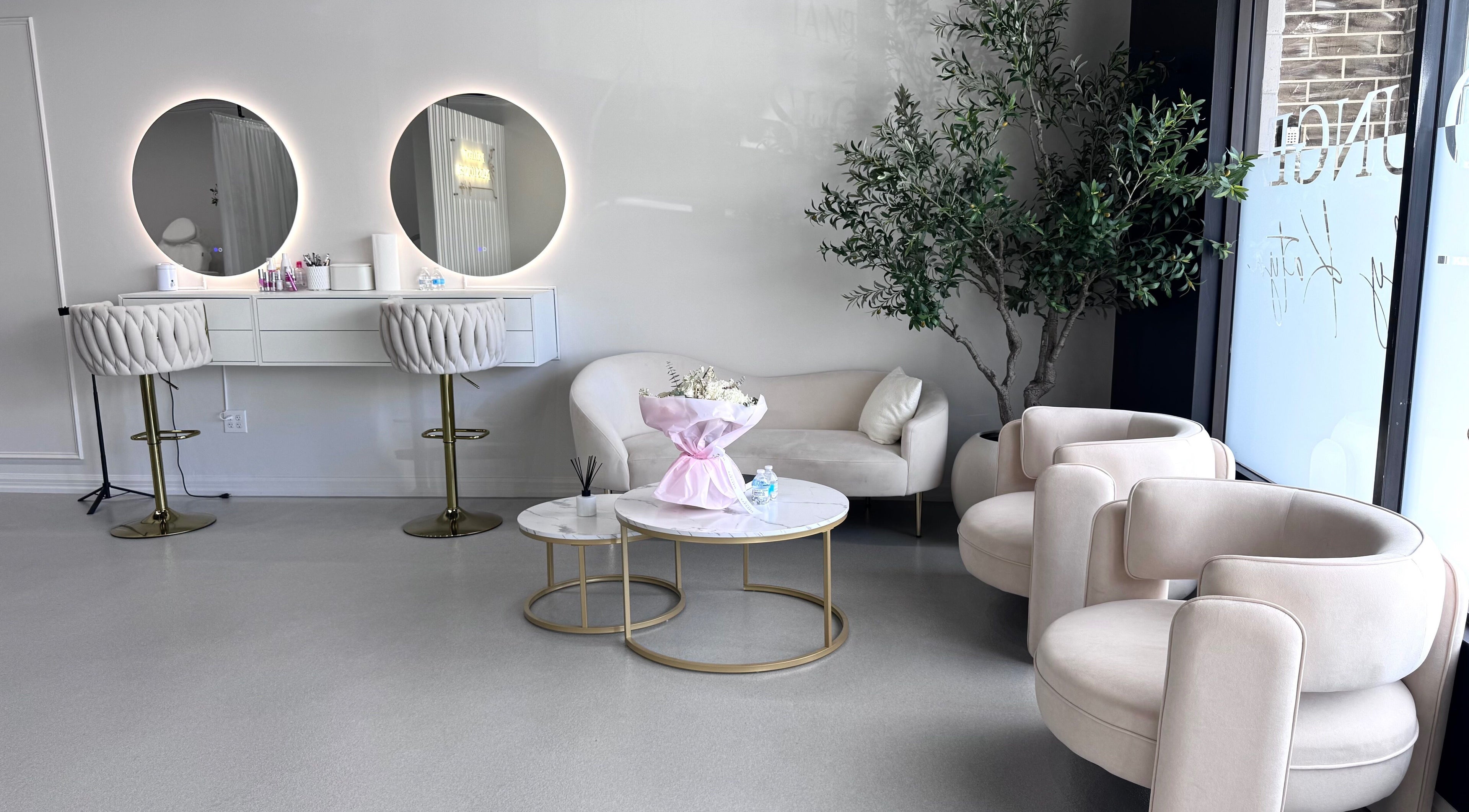 Elegant seating area at Brilliant Nails Lounge, Schaumburg, Illinois, US, showcasing modern decor and mirrors.