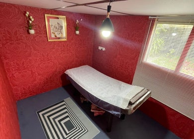 Tranquil treatment room at Nifty Lash and Beauty, Hamilton, Waikato, NZ with elegant red decor.