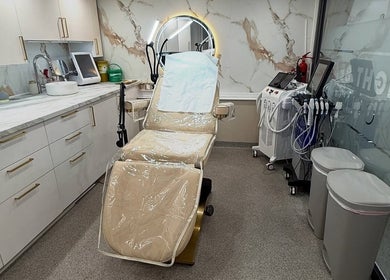 Modern treatment room at Bright Beauty Clinic, Great Saxham, England, GB, with plush chair and advanced equipment.