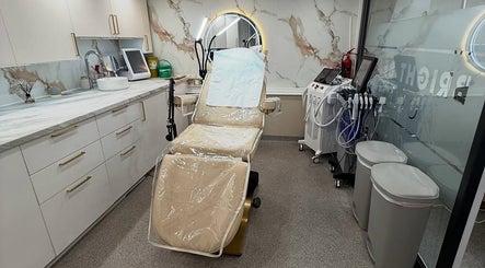 Modern treatment room at Bright Beauty Clinic, Great Saxham, England, GB, with plush chair and advanced equipment.