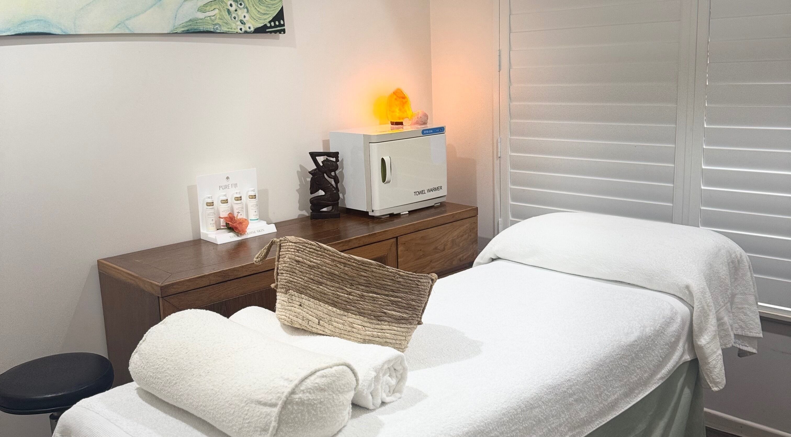 Relaxing therapy room at Sea Beauty Therapy in Trinity Park, Queensland, AU with a massage table and warm lighting.