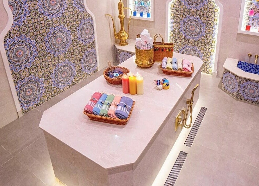 Luxurious spa room at R N J Ladies Salon, featuring vibrant decor and plush towels in Dubai, Dubai, AE.