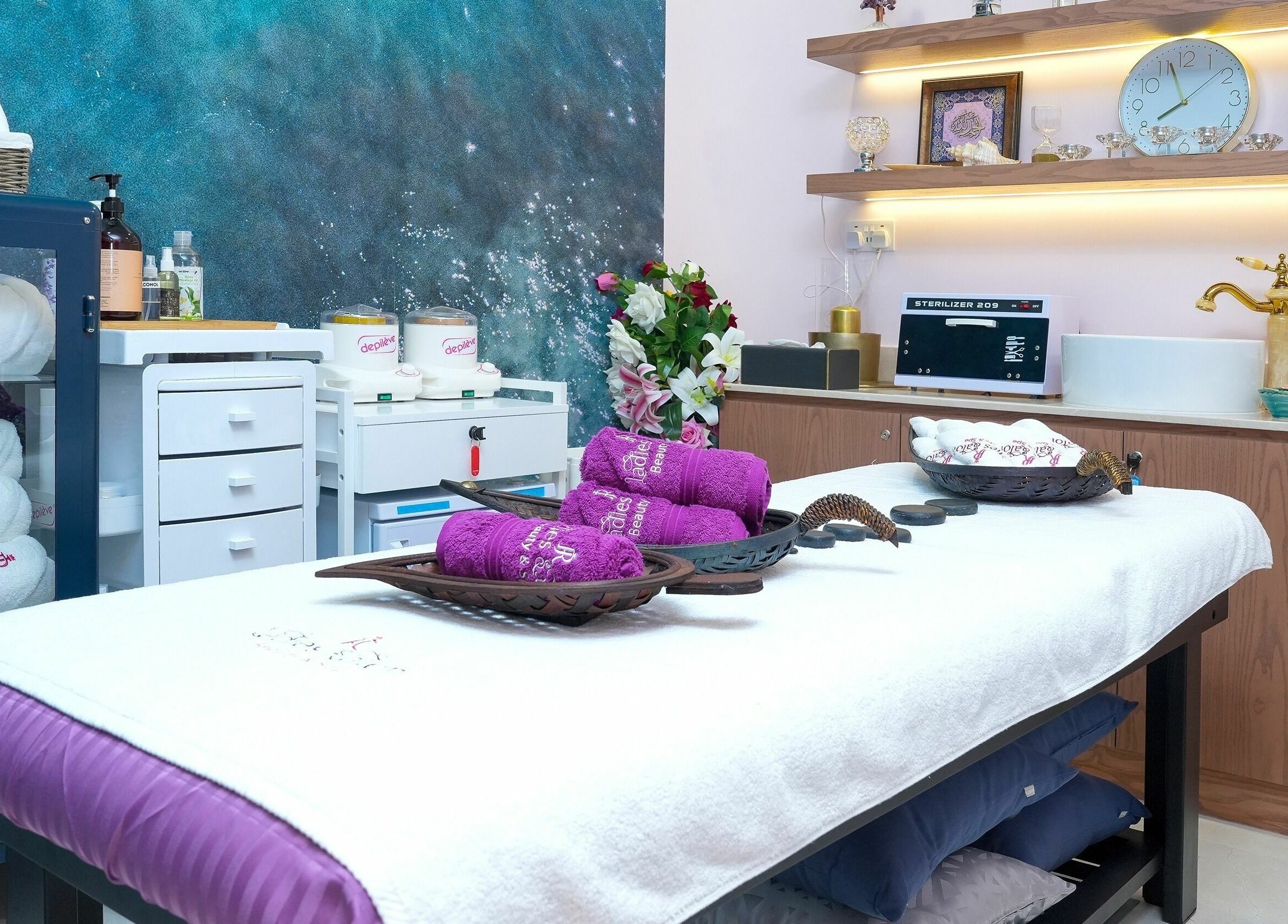 Elegant spa room at R N J Ladies Salon, Dubai, AE, featuring plush towels and serene decor.