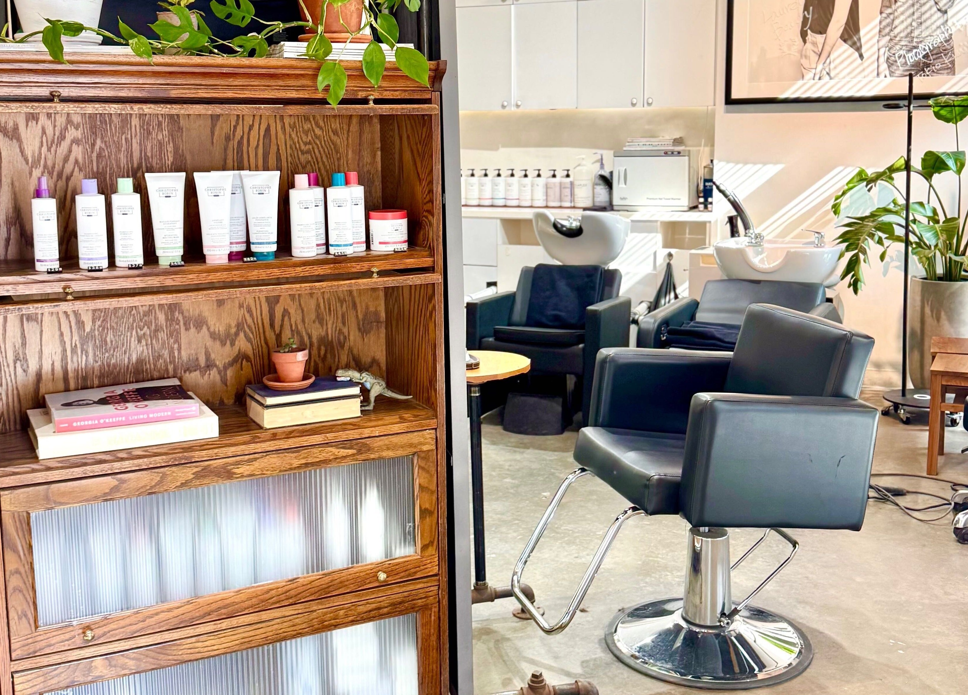 Modern salon interior at Laurel Bowery, New York with stylish chairs and product display.