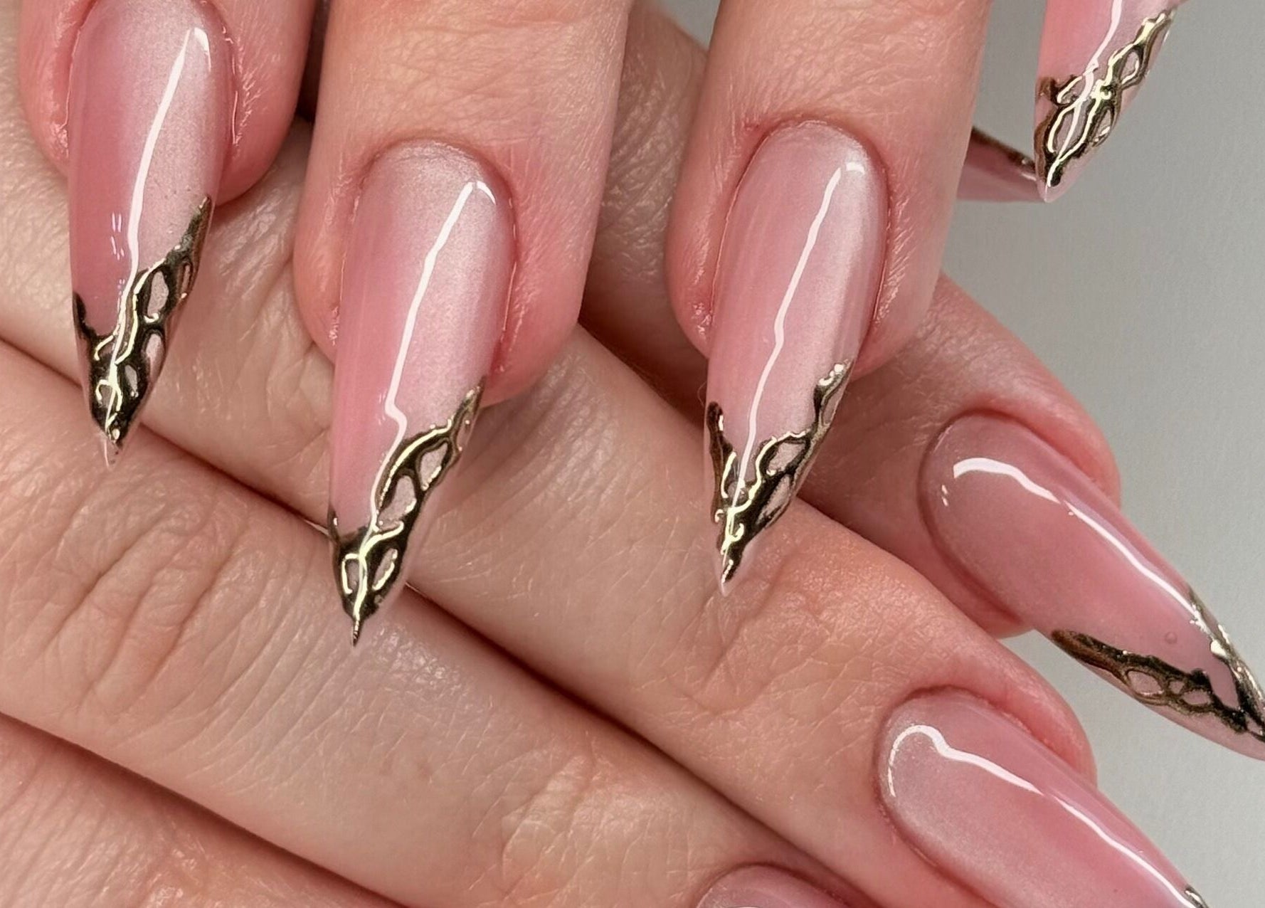 Intricate pink nails with gold accents at Chloe’s Shade Room in Tempe, Arizona, US.