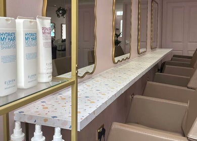Chic salon interior at Hairbyntash @ Shine Hair, Dundee, Scotland, GB showcasing stylish mirrors and products.