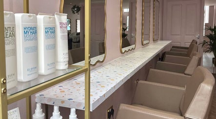 Chic salon interior at Hairbyntash @ Shine Hair, Dundee, Scotland, GB showcasing stylish mirrors and products.