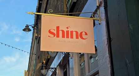 Sign for Hairbyntash @ Shine Hair in Dundee, Scotland, GB, showcasing elegant design.