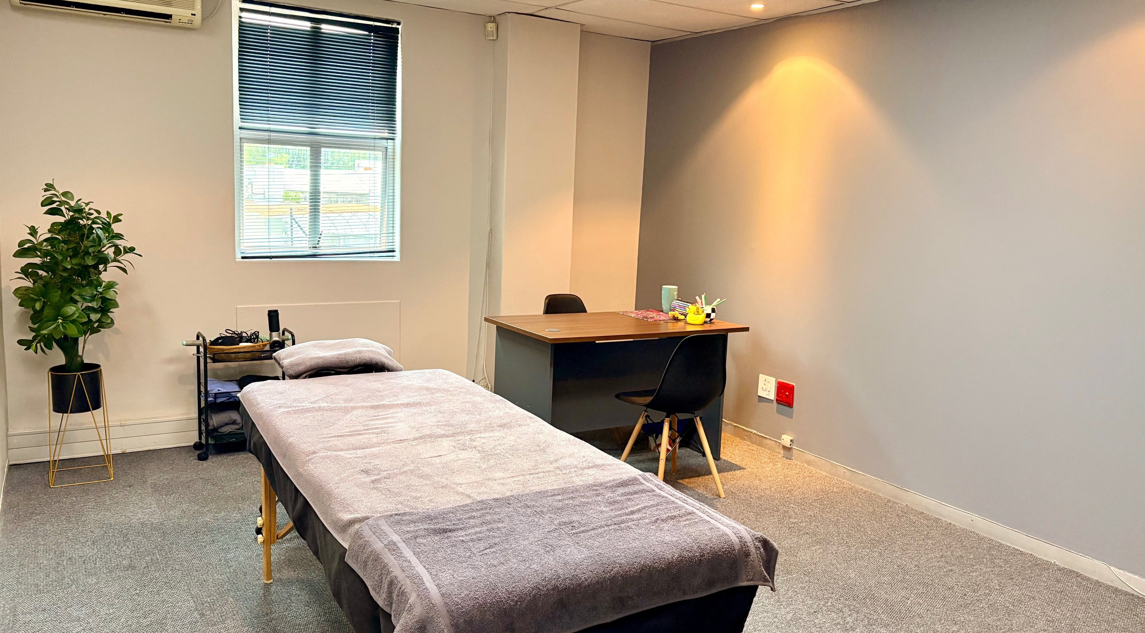 LX Sports Therapy room with massage bed and desk, Sandton, Gauteng, ZA.