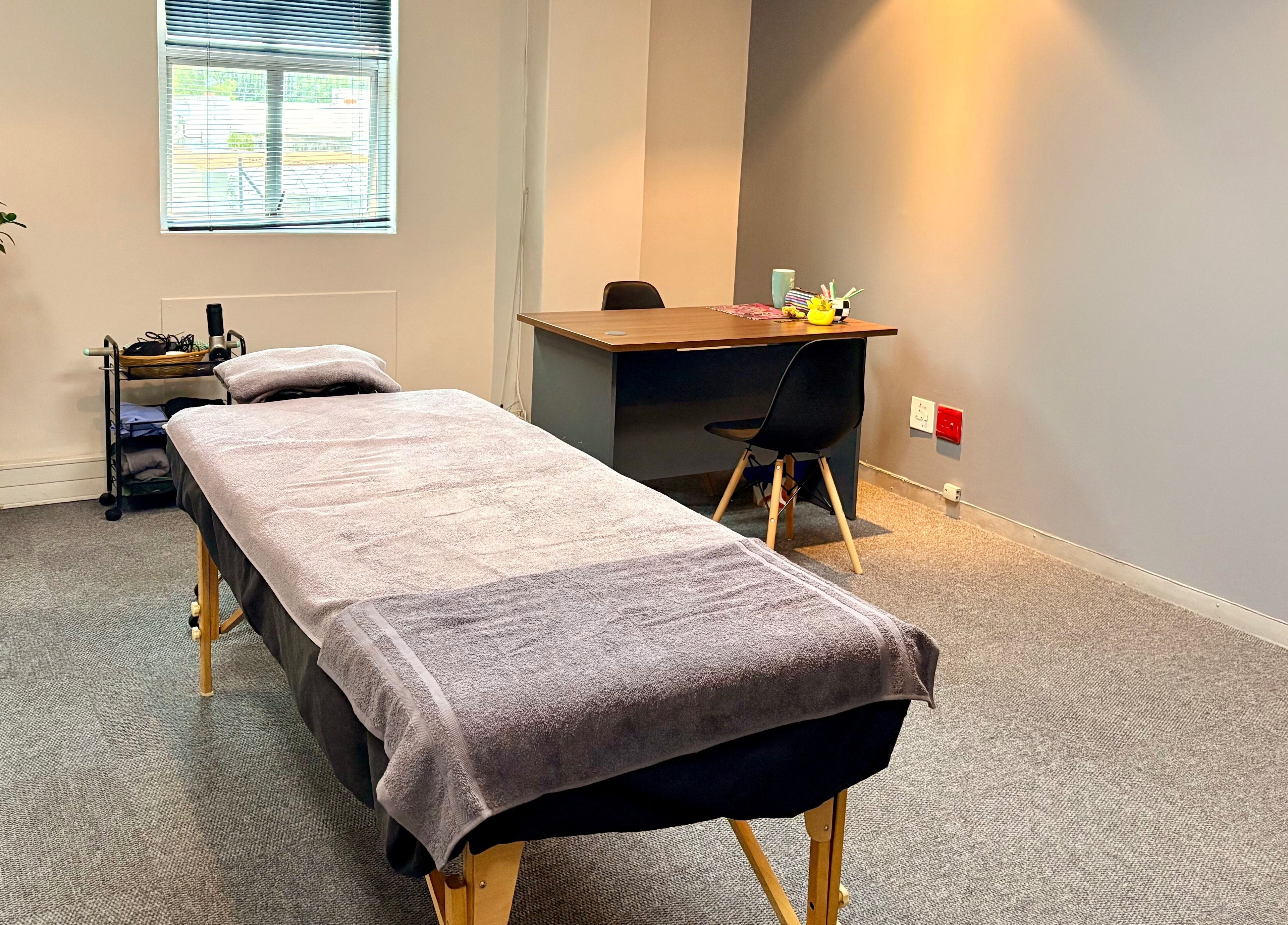 Relaxing treatment room at LX Sports Therapy, Sandton, Gauteng, ZA with massage table and modern decor.