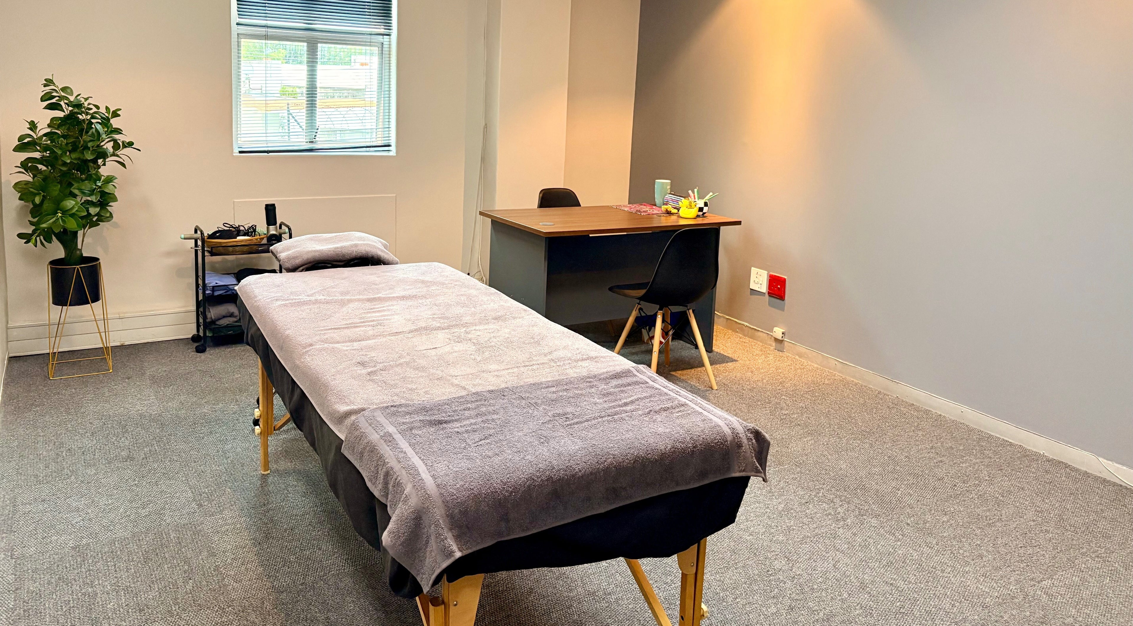 Relaxing treatment room at LX Sports Therapy, Sandton, Gauteng, ZA with massage table and modern decor.
