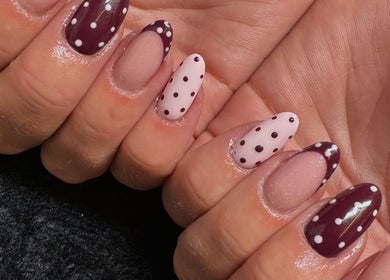 Stylish polka dot nails at EM BEAUTY, Egremont, England, GB, showcasing chic design.