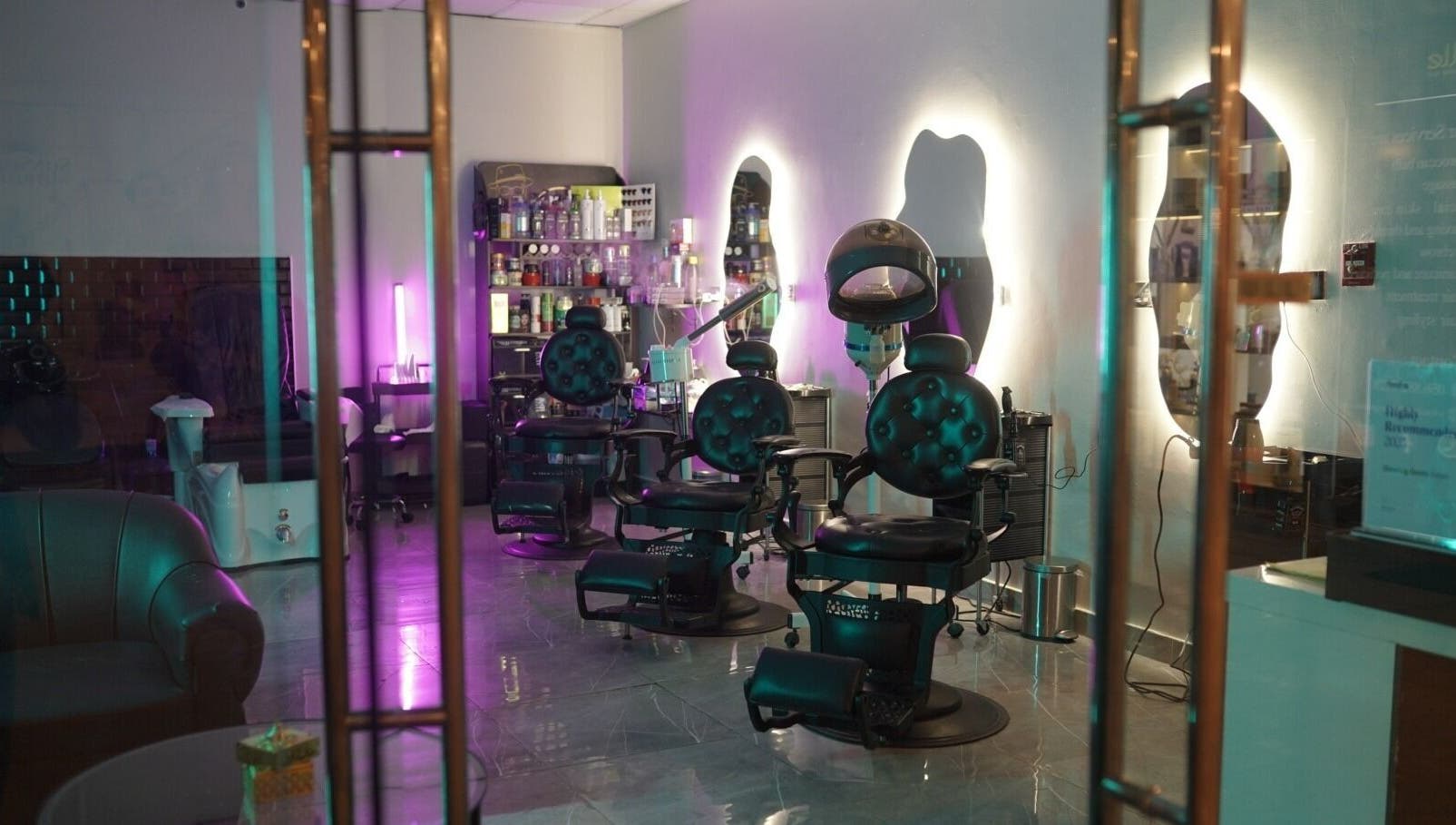 Chic interior of Glowing Gents Salon and SPA in Dubai, AE with stylish chairs and modern decor.