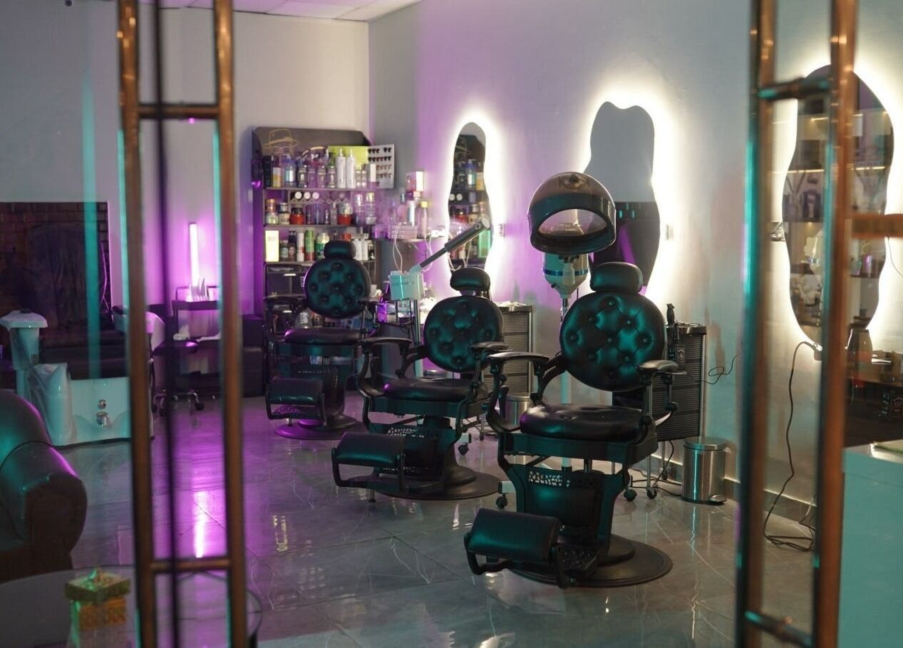 Chic interior of Glowing Gents Salon and SPA in Dubai, AE with stylish chairs and modern decor.